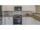 Modern kitchen with stainless steel appliances, subway tile, and granite countertops at 5096 S 245Th Dr, Buckeye, AZ 85326