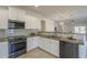 Modern kitchen boasts stainless steel appliances, granite countertops and bar top dining at 5096 S 245Th Dr, Buckeye, AZ 85326
