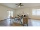 Bright living room features stylish furniture, decor, and sliding glass doors to backyard at 5096 S 245Th Dr, Buckeye, AZ 85326