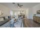Spacious living room with ceiling fan flows into the dining area and kitchen at 5096 S 245Th Dr, Buckeye, AZ 85326