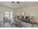 Bright living room features stylish furniture, decor, and sliding glass doors to backyard at 5096 S 245Th Dr, Buckeye, AZ 85326
