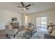 Bright living room features stylish decor, wood floors, and sliding glass doors to backyard at 5096 S 245Th Dr, Buckeye, AZ 85326
