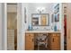 Bathroom vanity with a brightly decorated chair and a view into the shower at 5154 N 83Rd St, Scottsdale, AZ 85250