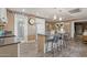 Open kitchen boasts an island with bar seating, wood-look floors, and stainless steel appliances at 5154 N 83Rd St, Scottsdale, AZ 85250