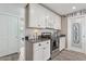 Kitchen with white cabinets, stainless steel appliances, and adjacent pantry at 5154 N 83Rd St, Scottsdale, AZ 85250