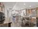 Open kitchen and dining area with white cabinets, breakfast bar, and modern appliances at 5154 N 83Rd St, Scottsdale, AZ 85250