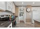 Galley kitchen with stainless steel appliances, white cabinetry, and wood-look floors at 5154 N 83Rd St, Scottsdale, AZ 85250