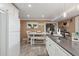 Bright eat-in kitchen features white cabinetry, gray countertops, and a farmhouse-style dining area at 5154 N 83Rd St, Scottsdale, AZ 85250