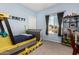 Charming bedroom features a unique bulldozer-themed bed, carpet floors, and black out curtains at 5321 N 196Th Ave, Litchfield Park, AZ 85340