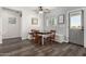Cozy dining area featuring wood-look floors, ceiling fan, and a built-in bench with table and chairs at 5321 N 196Th Ave, Litchfield Park, AZ 85340