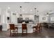 Elegant kitchen with a large island, granite countertops, pendant lighting, and modern appliances at 5321 N 196Th Ave, Litchfield Park, AZ 85340