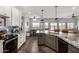 Modern kitchen featuring stainless steel appliances, granite countertops, an island and an adjacent dining area at 5321 N 196Th Ave, Litchfield Park, AZ 85340