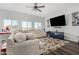 Spacious living room featuring large windows, a cozy sectional sofa, and a decorative area rug at 5321 N 196Th Ave, Litchfield Park, AZ 85340