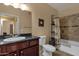 Bathroom with dark vanity, framed mirror, tiled shower and tub at 5335 E Shea Blvd # 1094, Scottsdale, AZ 85254
