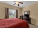 This bedroom has a ceiling fan, tile flooring, and a large window for natural light at 5335 E Shea Blvd # 1094, Scottsdale, AZ 85254