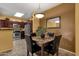 This dining room features a modern light fixture and has an open floor plan to the kitchen at 5335 E Shea Blvd # 1094, Scottsdale, AZ 85254