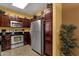 Kitchen featuring stainless steel appliances, dark cabinets, and tiled floors at 5335 E Shea Blvd # 1094, Scottsdale, AZ 85254