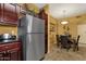 Kitchen with stainless steel refrigerator, dark cabinets, and dining area at 5335 E Shea Blvd # 1094, Scottsdale, AZ 85254