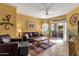 This living room has tiled floors, brown leather furniture, and access to a patio at 5335 E Shea Blvd # 1094, Scottsdale, AZ 85254