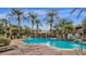 Community pool area featuring clear blue water, palm trees, lounge chairs, and seating areas at 5335 E Shea Blvd # 1094, Scottsdale, AZ 85254