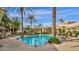 Beautiful community pool area with clear blue water, palm trees, and lounge chairs at 5335 E Shea Blvd # 1094, Scottsdale, AZ 85254