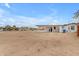View of the backyard with ample land surrounding the house at 546 N 96Th Pl, Mesa, AZ 85207