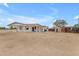 View of the backyard with ample land surrounding the house and a small storage shed at 546 N 96Th Pl, Mesa, AZ 85207