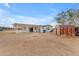 View of the backyard with ample land surrounding the house and a small storage shed at 546 N 96Th Pl, Mesa, AZ 85207
