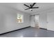 Bedroom featuring a modern ceiling fan, window view and access to bathroom at 546 N 96Th Pl, Mesa, AZ 85207