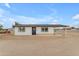 Inviting single-level home featuring a neatly painted white exterior, black-trimmed windows and a convenient side carport at 546 N 96Th Pl, Mesa, AZ 85207