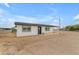 Charming single-story home with fresh white paint, new black roof, and a spacious dirt front yard under a bright blue sky at 546 N 96Th Pl, Mesa, AZ 85207