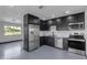 Modern kitchen with stainless steel appliances, dark cabinets, and white countertops at 546 N 96Th Pl, Mesa, AZ 85207
