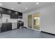 Open kitchen with stainless appliances, dark cabinets, and adjacent outdoor access at 546 N 96Th Pl, Mesa, AZ 85207