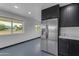 Bright kitchen features stainless steel refrigerator, stone countertop and white brick walls at 546 N 96Th Pl, Mesa, AZ 85207