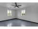 Bright living room featuring a modern ceiling fan and white brick walls and neutral flooring at 546 N 96Th Pl, Mesa, AZ 85207