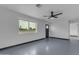 Bright living room features a ceiling fan, large window with street views, and freshly painted walls at 546 N 96Th Pl, Mesa, AZ 85207