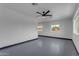 Open living space with ceiling fan, neutral walls, and ample natural light from the windows at 546 N 96Th Pl, Mesa, AZ 85207