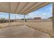Covered patio area with a concrete floor surrounded by a chain-link fence and a shed in the backyard at 546 N 96Th Pl, Mesa, AZ 85207