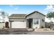 Charming one-story home with a gray exterior, a two-car garage, and well-manicured landscaping at 5901 S Red Rock St, Gilbert, AZ 85298