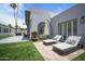 Inviting backyard features lounge chairs, a fountain, outdoor seating, and artificial grass for low-maintenance enjoyment at 6333 N Scottsdale Rd # 5, Scottsdale, AZ 85250