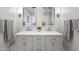 Elegant bathroom featuring a double vanity with modern faucets, white countertops and decorative mirrors at 6333 N Scottsdale Rd # 5, Scottsdale, AZ 85250