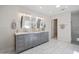 Bright primary bathroom with dual sink vanity, decorative mirrors and hardware, and a walk-in shower at 6333 N Scottsdale Rd # 5, Scottsdale, AZ 85250