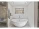 Beautiful bathroom featuring a soaking tub, walk-in shower, modern fixtures, and a sky light at 6333 N Scottsdale Rd # 5, Scottsdale, AZ 85250