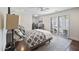 Comfortable bedroom with a cozy bed, ceiling fan, and access to outdoor through shuttered glass doors at 6333 N Scottsdale Rd # 5, Scottsdale, AZ 85250
