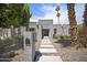 Stunning modern home featuring a desert landscape with cacti, a concrete walkway, and a neutral-toned facade at 6333 N Scottsdale Rd # 5, Scottsdale, AZ 85250