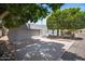 Spacious garage with a wide driveway offering ample parking space, and mature trees surrounding the property at 6333 N Scottsdale Rd # 5, Scottsdale, AZ 85250