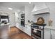 Modern kitchen featuring stainless steel appliances, white cabinetry, and hardwood floors at 6333 N Scottsdale Rd # 5, Scottsdale, AZ 85250