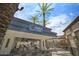 Stylish outdoor bar with palm trees, seating, and a modern design, creating a relaxed and inviting atmosphere at 6333 N Scottsdale Rd # 5, Scottsdale, AZ 85250