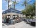 Inviting outdoor bar area with ample seating, palm trees, and a modern design, perfect for social gatherings and relaxation at 6333 N Scottsdale Rd # 5, Scottsdale, AZ 85250