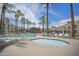 Large pool with lounge chairs and palm trees, offering a relaxing and luxurious outdoor experience in a resort-style setting at 6333 N Scottsdale Rd # 5, Scottsdale, AZ 85250